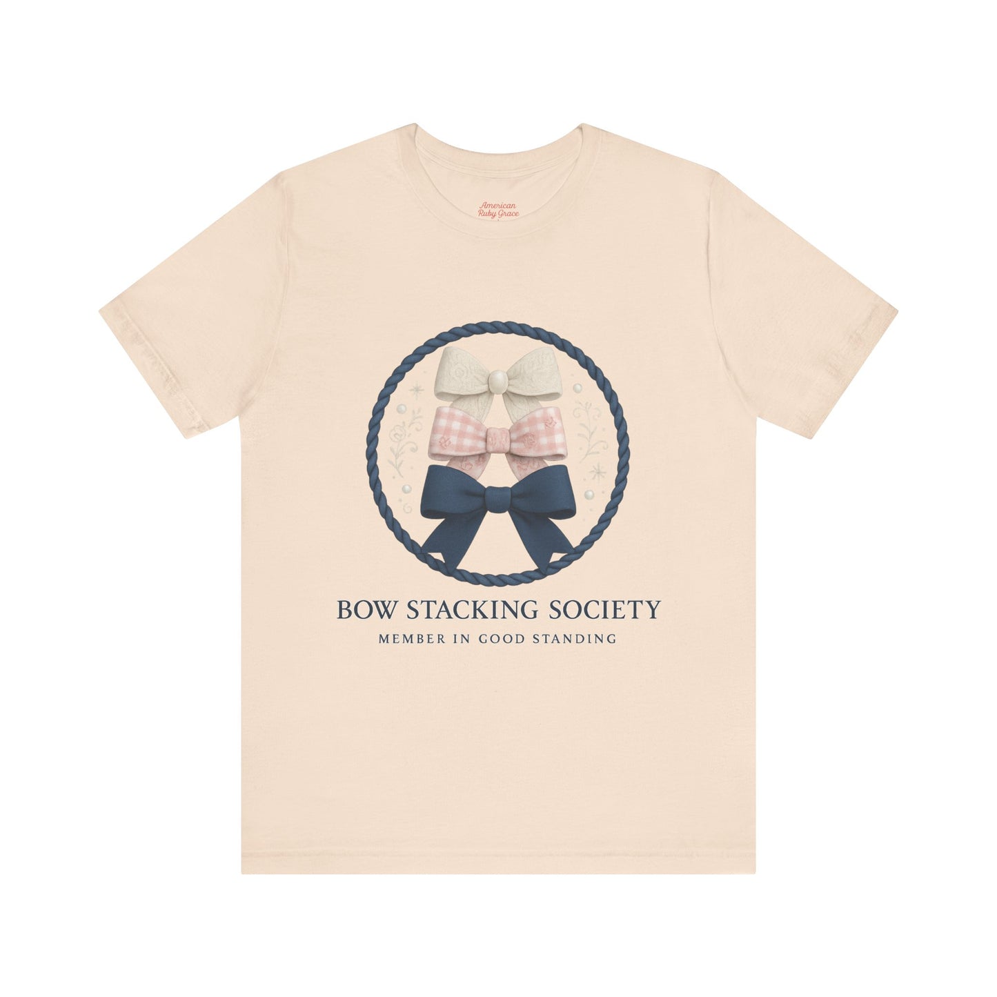 Beige T-shirt featuring Bow Stacking Society graphic with stacked bows and rope motif.