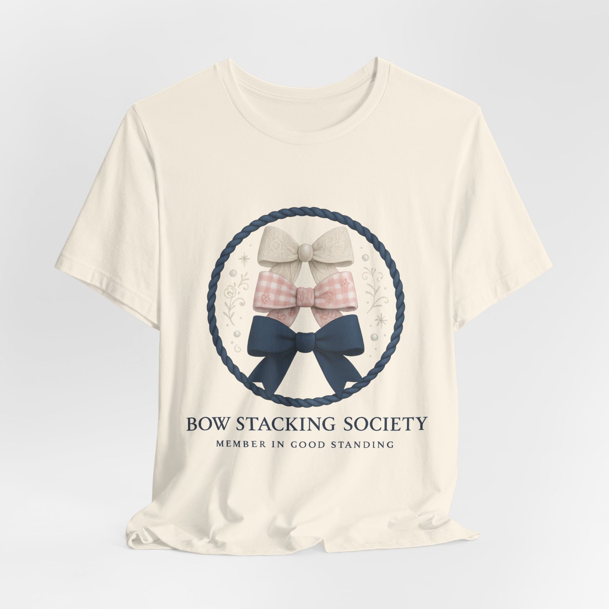Cream T-shirt featuring Bow Stacking Society logo with stacked bows and rope motif.